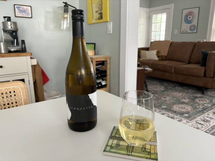 glass of white wine next to bottle of Mick Schroeter Russian River Chardonnay 2023