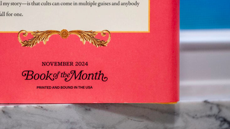 November book of the month logo on the back of a book