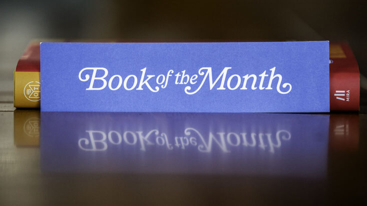 book of the month club bookmark leans against a book