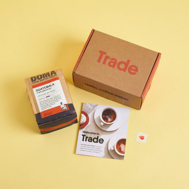 A box of Trade coffee along with what's inside.