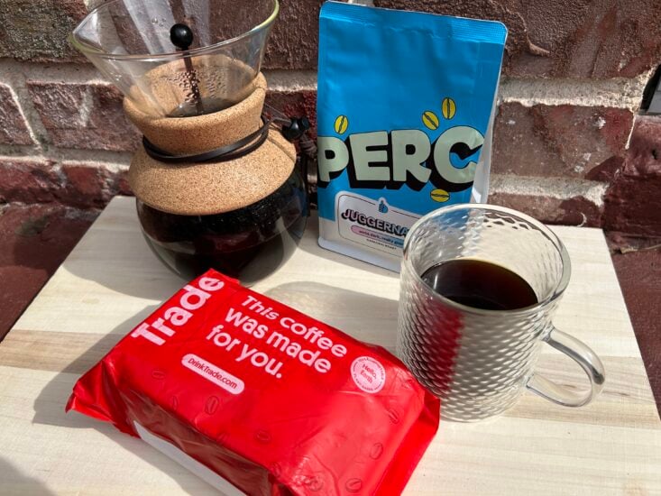 a bag of Trade Coffee in front of a pour over maker and bag of PERC Juggernaut coffee 