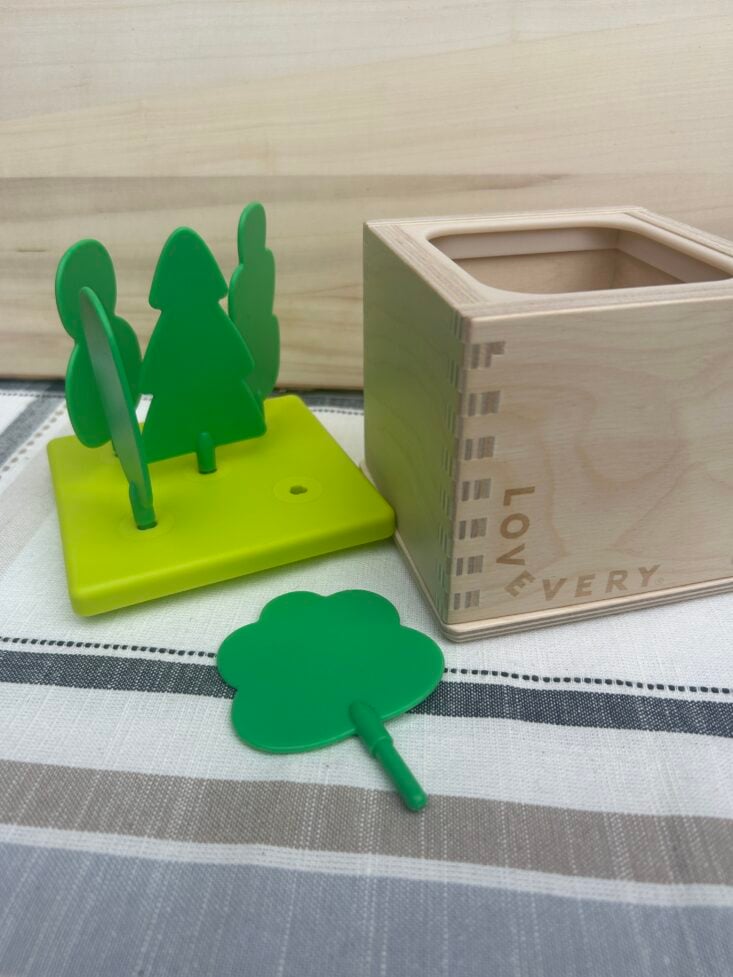 lovevery tree toy box with lid next to it