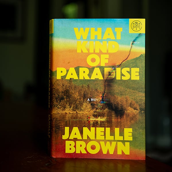 What Kind of Paradise by Janelle Brown book sitting on a shelf