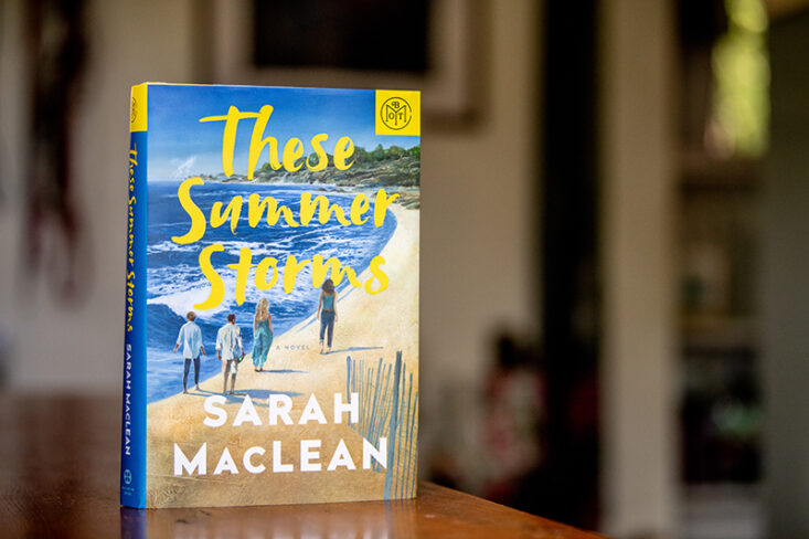 These summer storms book on table with BOTM logo in corner