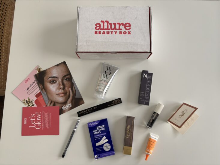 Allure Beauty Box skincare, makeup and haircare products on white background