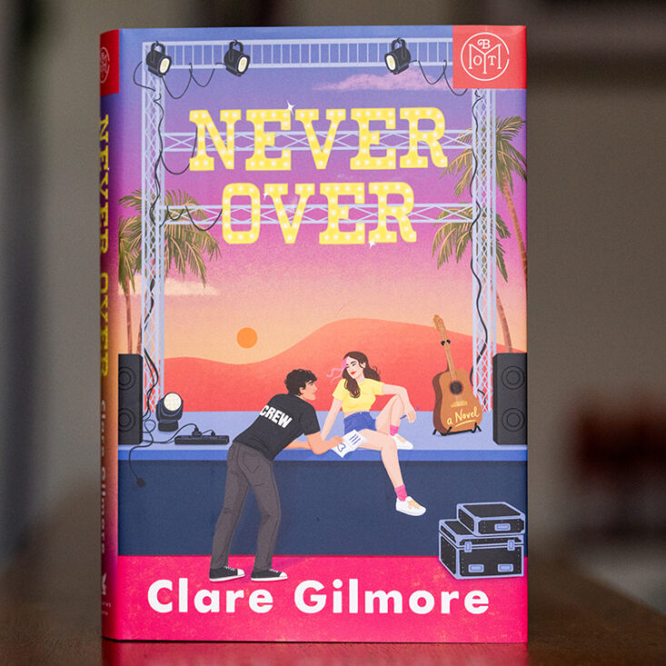 the book Never Over by Clare Gilmore sits on a shelf
